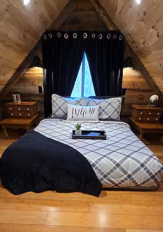 Cozy Cabin loft bed beneath the wood ceiling