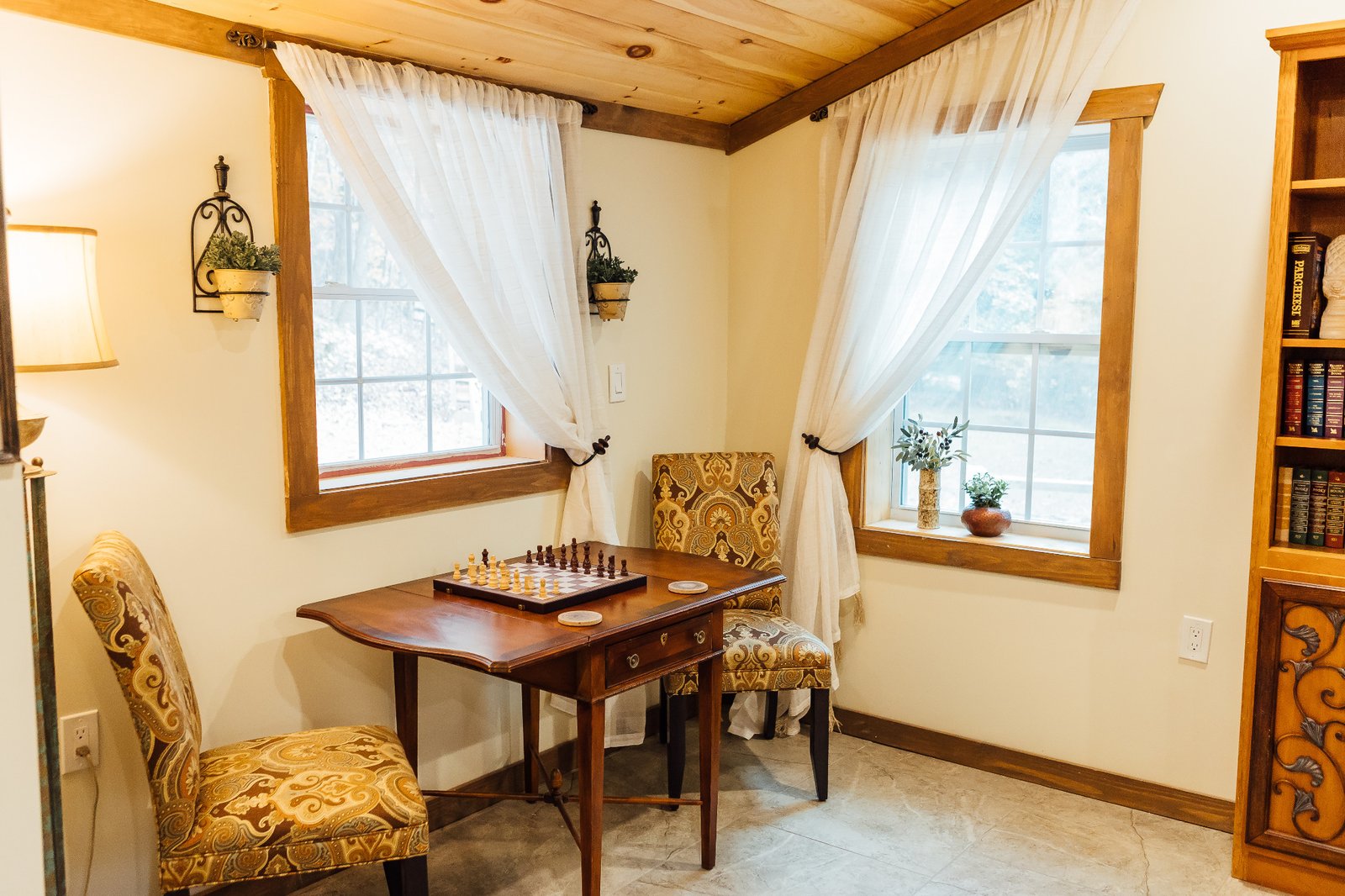 Villa Serena chess table beside two windows