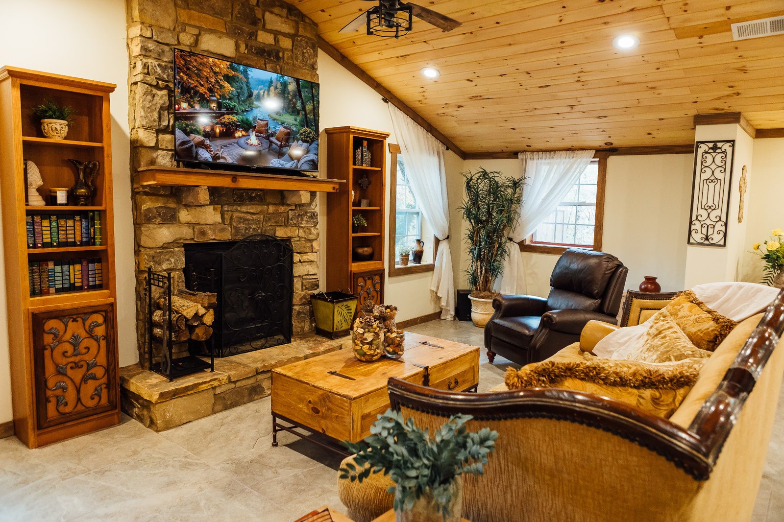 Villa Serena living room with a stone fireplace and sofa